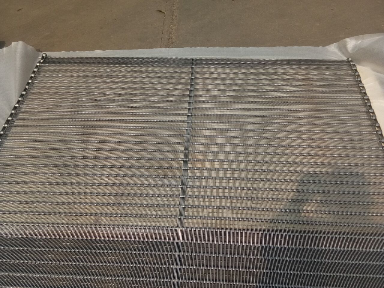 Top view photo example showing metal conveyor belt surface pattern